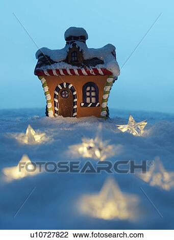 Stock Image - Christmas Decorations near Model House. Fotosearch