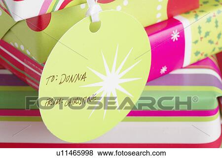 Christmas presents with tags (close-up) View Large Photo Image Stock Photo - Christmas presents with tags (close-up). Fotosearch