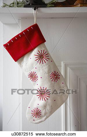 Christmas stocking hanging from shelf View Large Photo Image Stock Photography - Christmas stocking hanging from shelf. Fotosearch