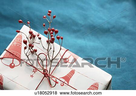 Decorative branch with berries on Christmas present (close-up) View Large Photo Image Stock Photo - Decorative branch with berries on Christmas present (close-up). Fotosearch
