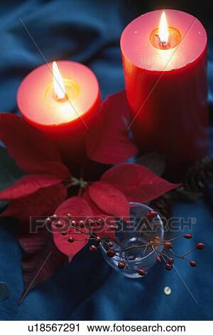 Poinsettia and holly branch near candles (high angle view) View Large Photo Image Stock Image - Poinsettia and holly branch near candles (high angle view). Fotosearch