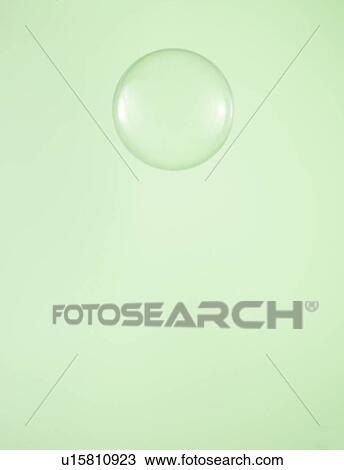 Stock Image - Single Water Droplet on Green Background. Fotosearch