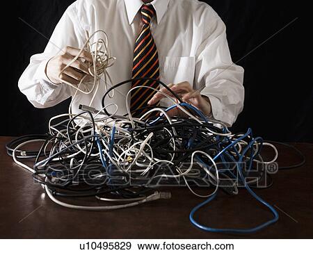 Stock Photo - Businessman Arranging Leads. Fotosearch