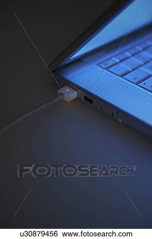Stock Photograph - Powerlead Attached to Laptop. Fotosearch