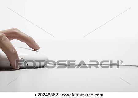 Stock Image - Woman's hand on computer mouse (close-up). Fotosearch