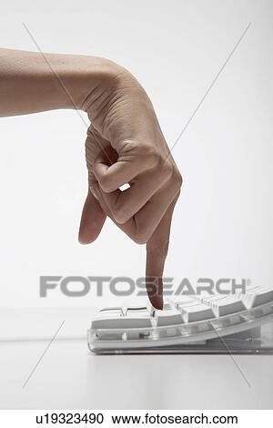 Young woman typing with index finger (close-up) View Large Photo Image Stock Image - Young woman typing with index finger (close-up). Fotosearch