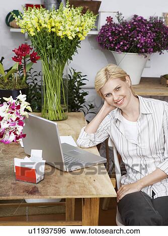 Female florist with laptop (portrait) View Large Photo Image Stock Photograph - Female florist with laptop (portrait). Fotosearch