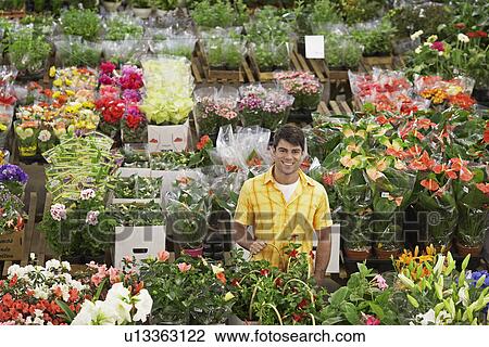 Stock Image - Male customer in flower shop. Fotosearch
