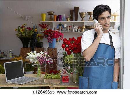 Stock Photography - Male florist on phone. Fotosearch