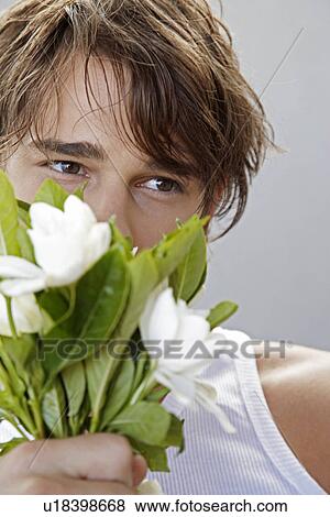 Stock Photo - Young Man Holding Bunch of Flowers. Fotosearch