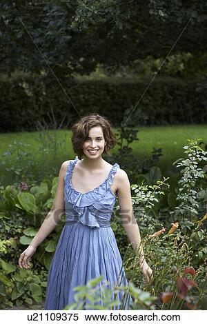 Stock Photography - Young woman in garden. Fotosearch