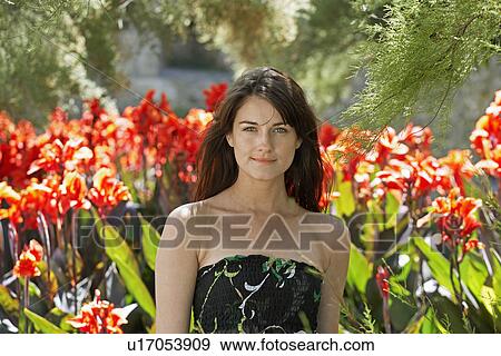 Young Woman Near Flowers View Large Photo Image Stock Photo - Young Woman Near Flowers. Fotosearch