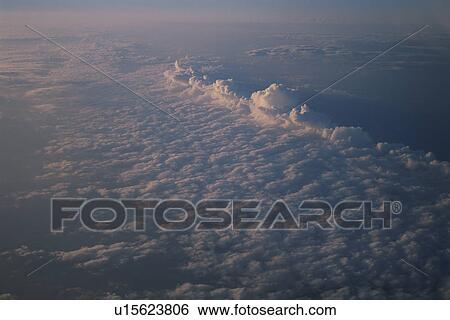 Stock Photograph - A Sea Of Clouds And Evening Glow. Fotosearch