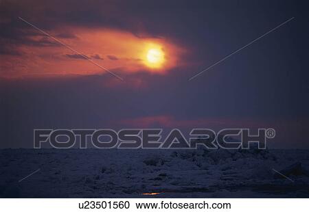 Stock Image - Drift Ice And The Setting Sun. Fotosearch