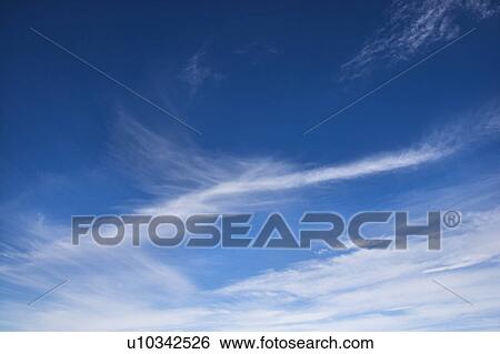 Stock Photograph - Cirrus clouds in blue sky. Fotosearch