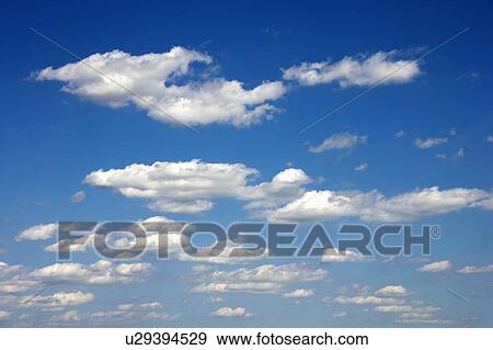Stock Photo - Cumulus clouds in blue sky. Fotosearch