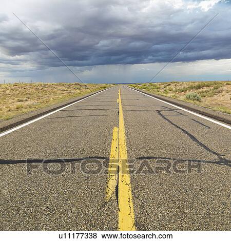 Stock Photo - Empty two lane highway leading to desert horizon. Fotosearch