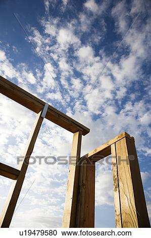 Frame wooden structure with cloudy blue sky in background View Large Photo Image Stock Image - Frame wooden structure with cloudy blue sky in background. Fotosearch