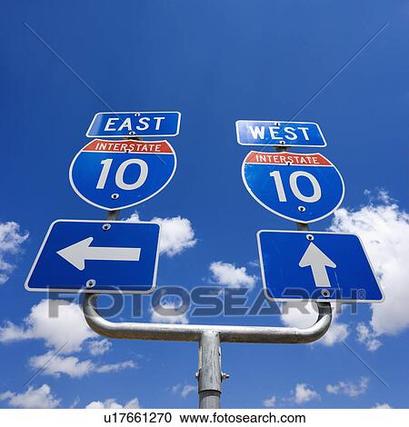 Stock Image - Highway interstate 10 sign with arrows pointing east and west. Fotosearch