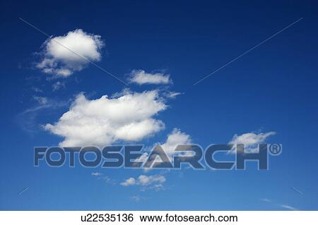 Stock Photograph - Peaceful clouds in blue sky.. Fotosearch