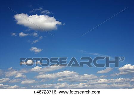 Stock Photograph - Peaceful clouds in blue sky.. Fotosearch
