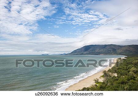Stock Photograph - Scenic coastal view from Queensland Rex Lookout with mountains in background under blue sky with clouds. Fotosearch