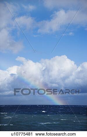 Seascape of the Pacific Ocean near Maui, Hawaii with rainbow and clouds. View Large Photo Image Stock Image - Seascape of the Pacific Ocean near Maui, Hawaii with rainbow and clouds.. Fotosearch
