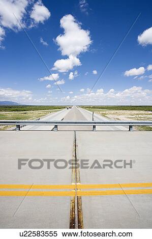 Solid double yellow line in road on overpass with highway below View Large Photo Image Stock Photography - Solid double yellow line in road on overpass with highway below. Fotosearch