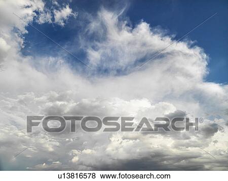 Stock Photo - White clouds in blue sky. Fotosearch