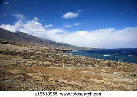Stock Photography - Barren landscape leading to Pacific ocean in Maui, Hawaii.. Fotosearch