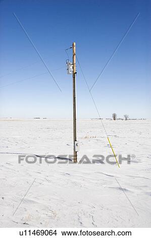 Power line in desolate snow covered rural landscape View Large Photo Image Picture - Power line in desolate snow covered rural landscape. Fotosearch