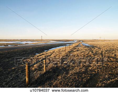 Stock Photo - Road with melted snow in rural setting.. Fotosearch
