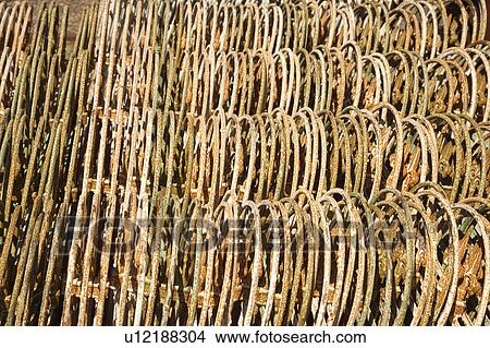 Metal fencing stacked in a row. View Large Photo Image Picture - Metal fencing stacked in a row.. Fotosearch