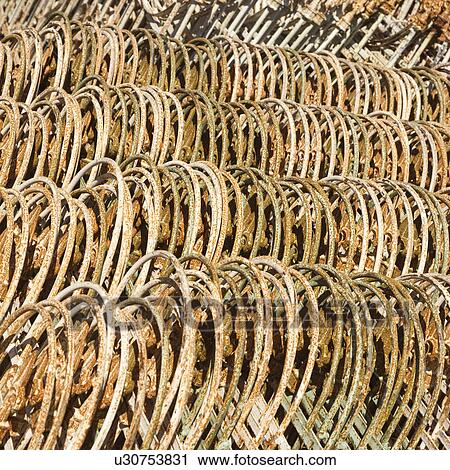Stock Image - Metal fencing stacked in a row.. Fotosearch
