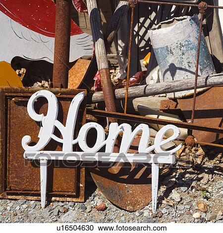 Metal figure with word 'Home' leaning against junk. View Large Photo Image Stock Image - Metal figure with word 'Home' leaning against junk.. Fotosearch