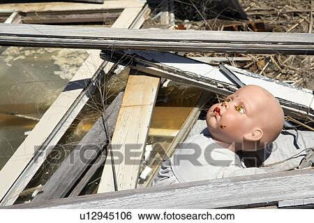 Old baby doll head sticking out of garbage at landfill View Large Photo Image Stock Photograph - Old baby doll head sticking out of garbage at landfill. Fotosearch