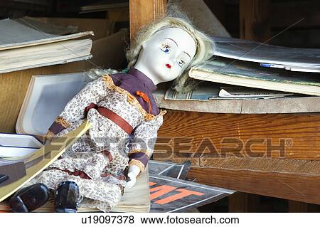 Old baby doll sitting on shelf. View Large Photo Image Stock Photo - Old baby doll sitting on shelf.. Fotosearch