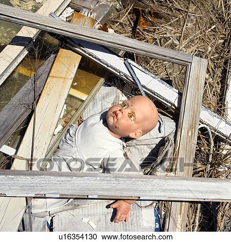 Old baby doll sticking out of garbage at landfill. View Large Photo Image Stock Image - Old baby doll sticking out of garbage at landfill.. Fotosearch