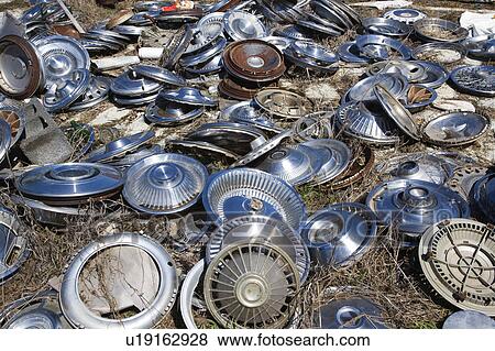 Old metal hubcaps strewn across the ground. View Large Photo Image Stock Photo - Old metal hubcaps strewn across the ground.. Fotosearch