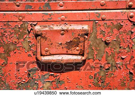 Stock Image - Old orange weathered metal storage container.. Fotosearch