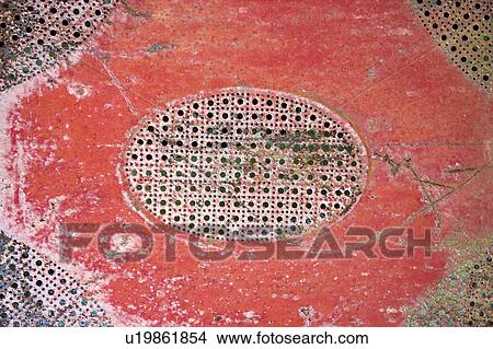 Picture - Old red patterned piece of metal.. Fotosearch