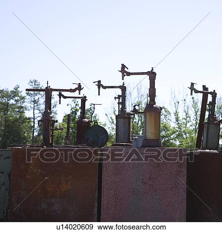 Old rusted metal machinery silhouetted against sky View Large Photo Image Stock Photo - Old rusted metal machinery silhouetted against sky. Fotosearch