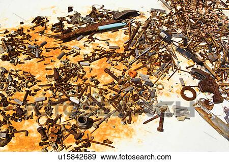 Stock Photo - Old rusty nails and screws on table. Fotosearch