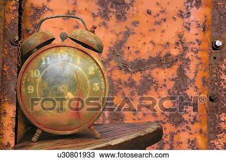 Old weathered alarm clock against rusty orange metal background. View Large Photo Image Stock Image - Old weathered alarm clock against rusty orange metal background.. Fotosearch