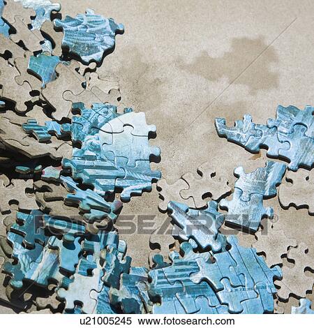 Stock Photography - Pieces of old puzzle lying scattered about.. Fotosearch