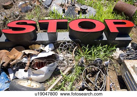Stock Image - Word 'STOP' lying amongst junk and garbage.. Fotosearch