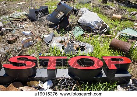 Stock Photograph - Word 'STOP' lying amongst junk and garbage.. Fotosearch