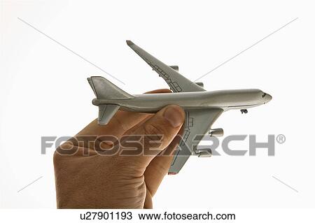 Hand holding toy airplane View Large Photo Image Stock Image - Hand holding toy airplane . Fotosearch