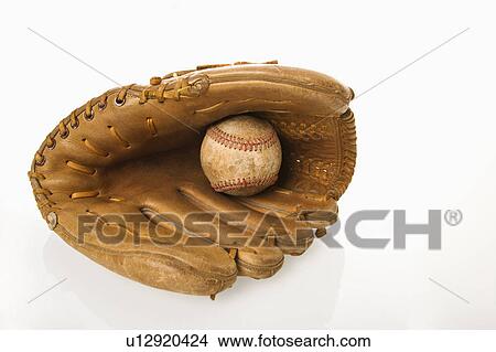 Picture - Baseball resting in baseball glove.. Fotosearch