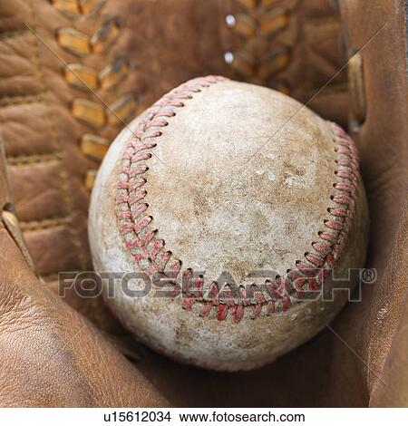 Picture - Close up of baseball resting in baseball glove. Fotosearch